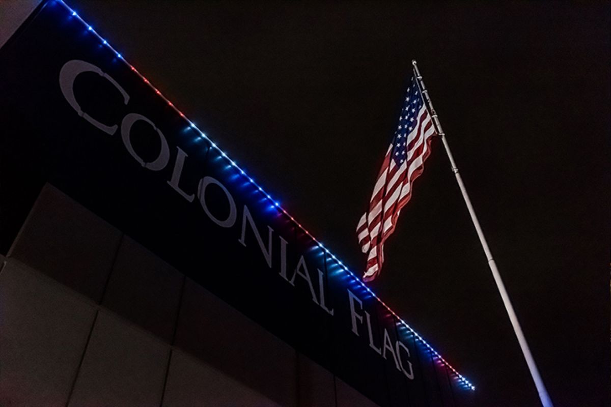 Storefront with red, white, and blue lights along the roofline
