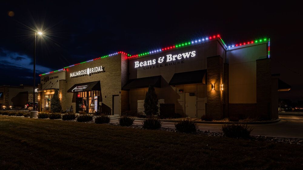 Retail building with red, green, and blue lights on the parapet