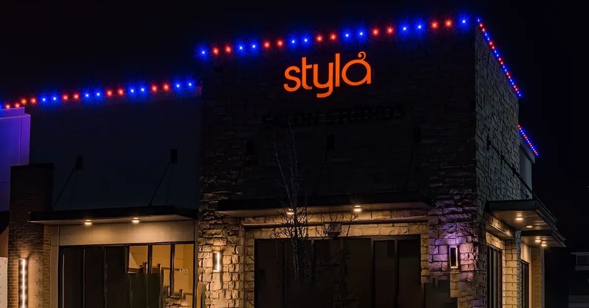 Stone commercial building with red and blue roofline lights