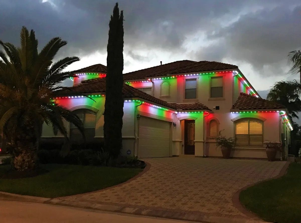 House with red, green, and blue holiday lights on the roof