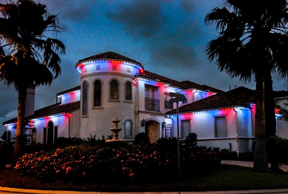 Home with red, white, and blue lights along the tile roof