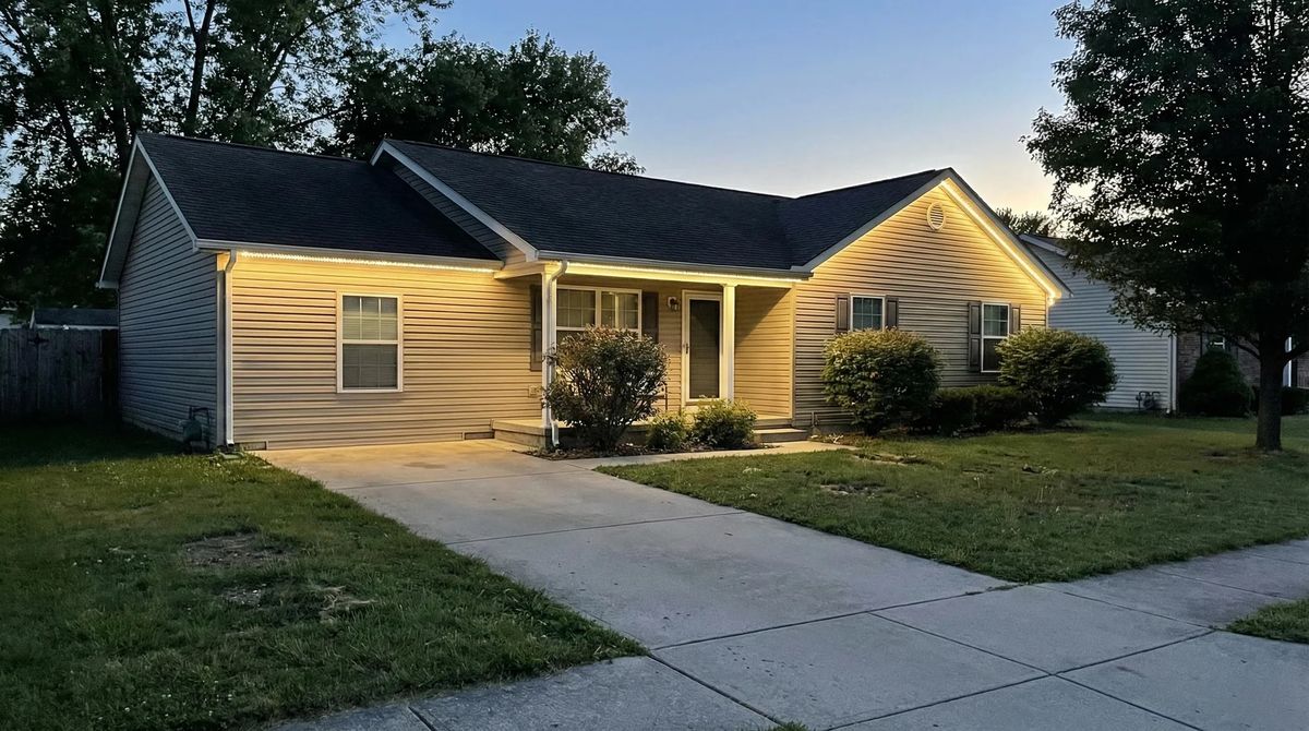 Home with a warm white wash across the porch and eaves