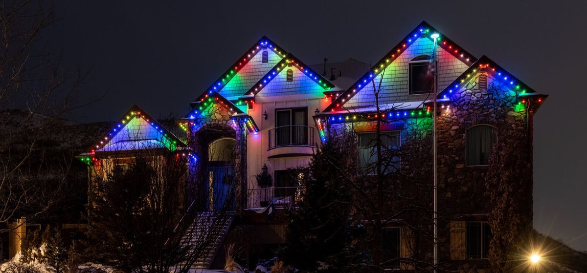 Stone house with a rainbow of lights along the gables